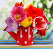 Beautiful tulips in bouquet on table on bright background