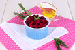Sliced beetroot on bowl on wooden table close-up