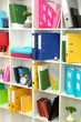 White office shelves with different stationery, close up
