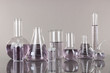 Photo: Test-tubes with light purple liquid on gray background Test-tubes with light purple liquid on gray background