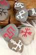 Fortune telling  with symbols on stones on white fur background