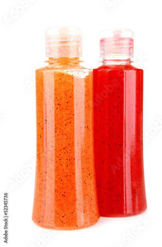 Photo: Bottles with scrub isolated on white Bottles with scrub isolated on white