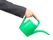 Hand of a businessman pouring water from watering can isolated