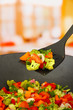 Vegetable ragout in wok, on bright background