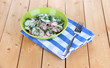 Vitamin vegetable salad in bowl on wooden table close-up