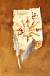 Old paper with symbols, on wooden background