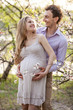 Photo: Young pregnant couple outdoors in spring Young pregnant couple outdoors in spring