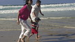 Happy family having fun on the beach