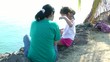 Mother talking with her daughter on the coast