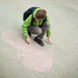 Boy drawing on road