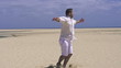 Young happy man having fun on the beach