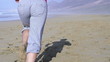 Woman jogging on beautiful beach, super slow motion, 240fps