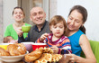 Foto: family drinks tea with baked at home family drinks tea with baked at home