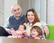 joyful family of four at their home