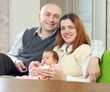 Happy mature man with wife and  baby