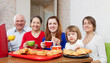 Foto: happy three generations family drinks tea happy three generations family drinks tea