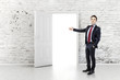 businessman in front of an open door in a vintage wall