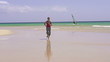 Young woman jogging on beautiful beach