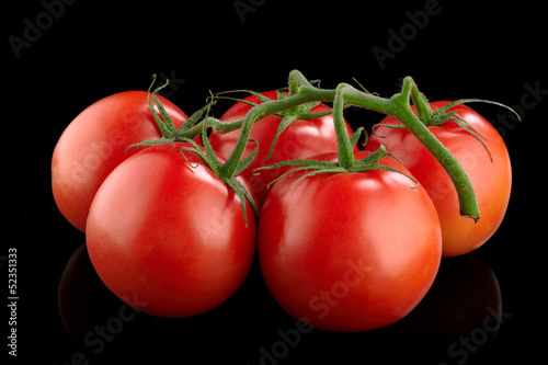 Photo: Red tomatoes on a black background Red tomatoes on a black background