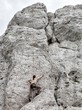 Young man climbing on limestone wall