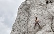 Young man climbing on limestone wall