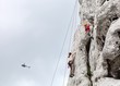 Young man and child climbing on limestone wall