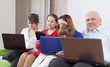 Happy multigenerations family with laptops  at home