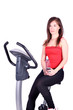 Photo: girl with bottle of water sitting on cross trainer girl with bottle of water sitting on cross trainer