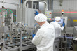 two workers at production line in plant