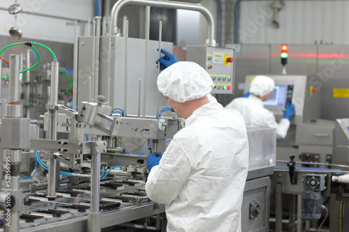 Photo: two workers at production line in plant two workers at production line in plant