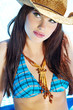 beautiful long hair female model posing by the pool,
