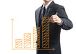 Business man drawing a growing chart