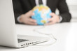 Computer connected to earth globe