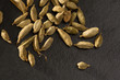cardamom spice macro detail over black slate stone