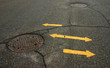 street with arrow and sewage