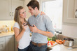 Couple in the kitchen drinking a glass of red wine