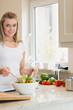 Happy woman preparing salad