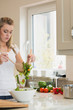 Photo: Woman preparing fresh salad Woman preparing fresh salad