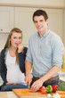 Pregnant woman eating vegetables prepared by husband