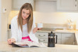 Photo: Woman drinking coffee while reading the newspaper Woman drinking coffee while reading the newspaper