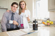 Couple reading newspaper and drinking coffee