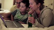 Vídeo: Happy family watching something on laptop in bedroom Happy family watching something on laptop in bedroom