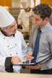 Photo: Chef and waiter having a discussion Chef and waiter having a discussion