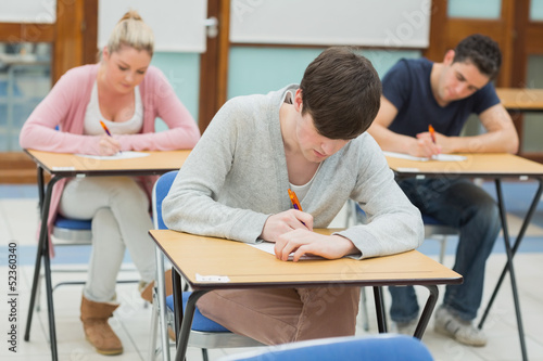 Photo: Writing students at desks in a classroom Writing students at desks in a classroom