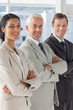 Photo: Three smiling business people standing together Three smiling business people standing together