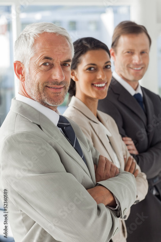 Photo: Cheerful business people looking in the same way Cheerful business people looking in the same way