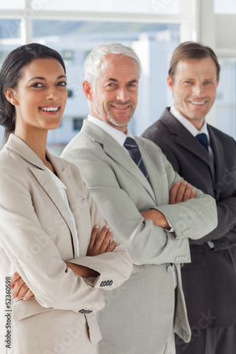 Photo: Three smiling business people standing together Three smiling business people standing together