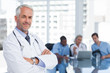 Photo: Smiling doctor with arms folded Smiling doctor with arms folded