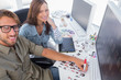 Two happy photo editors working with contact sheets