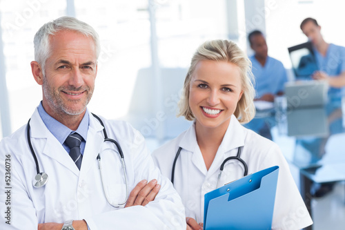 Photo: Doctors holding blue file Doctors holding blue file